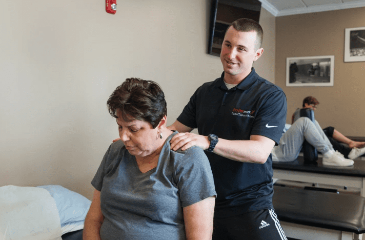 A man is helping someone with their neck.