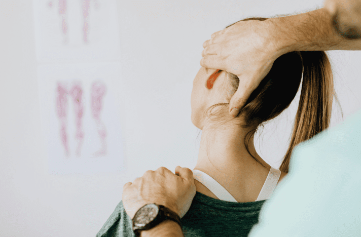 A woman is getting her hair combed by another person.