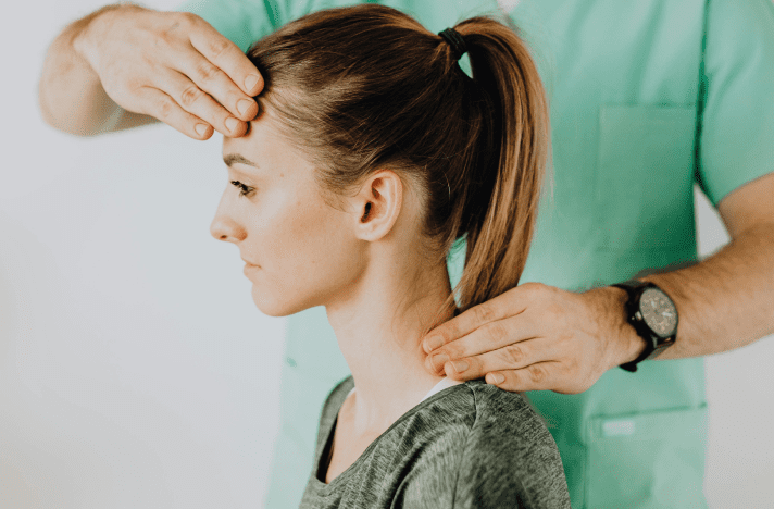 A woman getting her hair combed by a person.