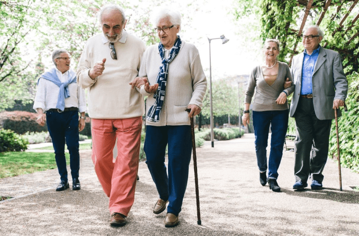 A group of people walking on the sidewalk.