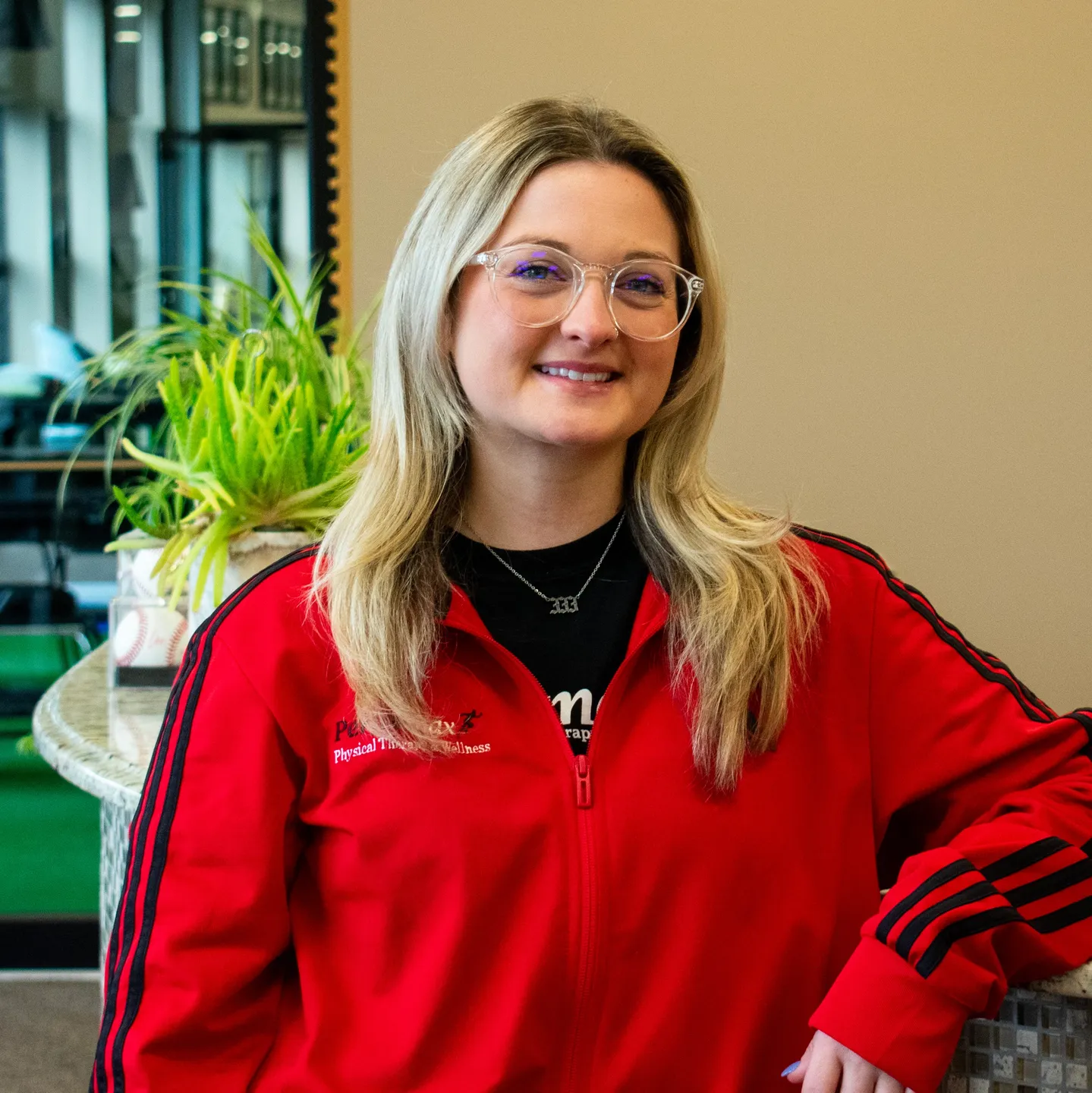 A woman in red jacket posing for the camera.