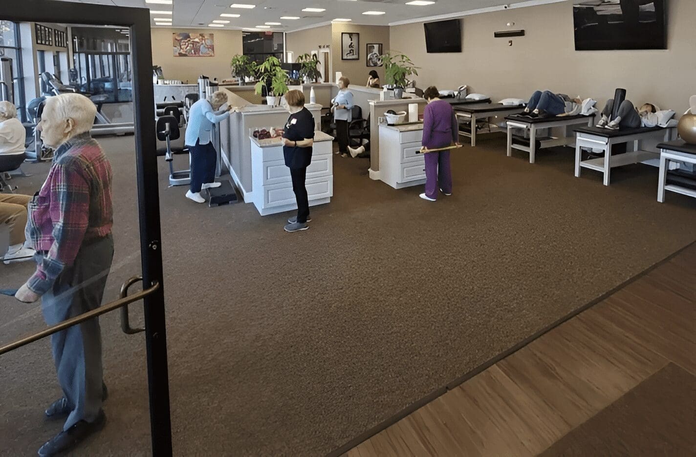 A group of people standing around in an office.